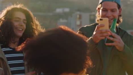 group of diverse friends hanging out dancing together african american woman enjoying rooftop party dance music at sunset drinking alcohol having fun on weekend gathering