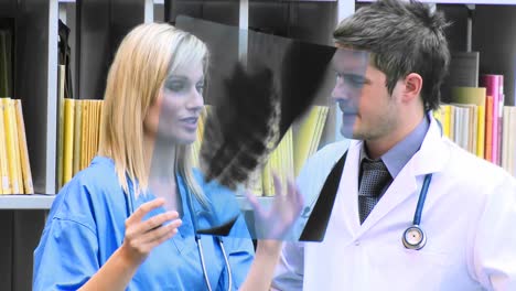 female and male doctors examining an xray in hospital footage