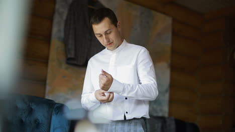 morning of the groom. handsome groom getting dressed and preparing for the wedding