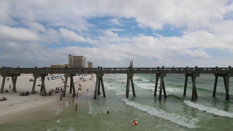 Florida---Casino-Beach-With-Beachgoers-under-Pensacola-Fishing-Pier---Aerial-landscape-View