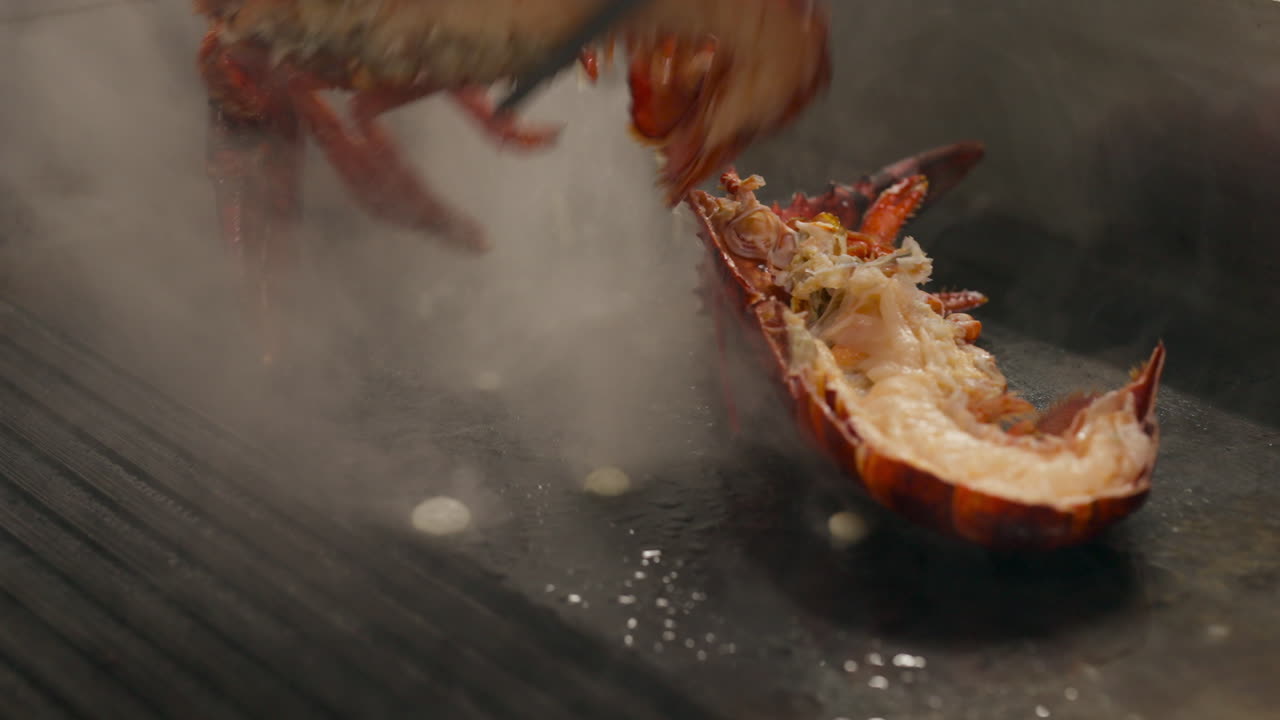 Flipping Delicious Lobster Cooking On Grill. closeup shot