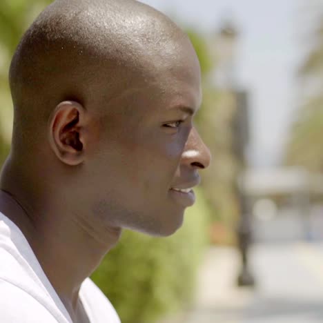 close up side view of handsome bald black man