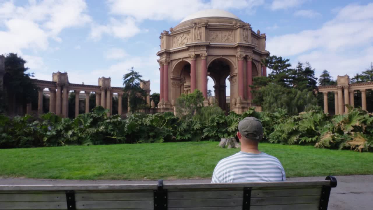 Man sits on park bench at the Art Palace in San Francisco, California