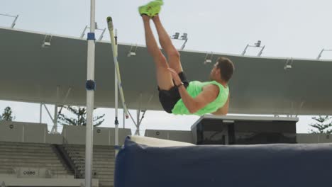 side view of caucasian athlete doing high jump