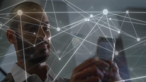 animation of network of connections over caucasian businessman using smartphone