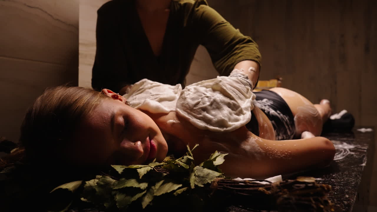Woman receiving a back massage in a spa