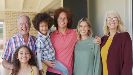 Video-of-happy-diverse-family-standing-outside-of-house