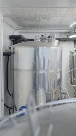 large stainless steel tank in an industrial processing facility