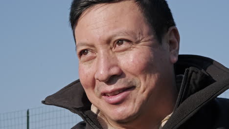 Portrait-Of-Ecuadorian-Man-Looking-In-Distance,-Turns-Head-And-Smile-At-Camera-On-A-Sunny-Day