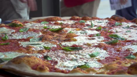 giant margarita pizza awaiting being eaten