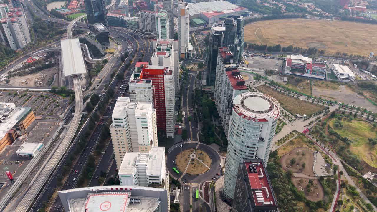 Drone flight over Santa Fe tallest buildings, showcasing avenues, rooftops and helipads, CDMX