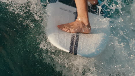 slow motion water splashing as wake surf board lands trick