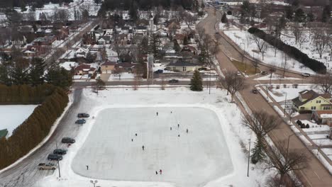 aerial, people ice skating on neighborhood community ice rink