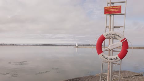 lifebuoy on the post erected on the lakeshore