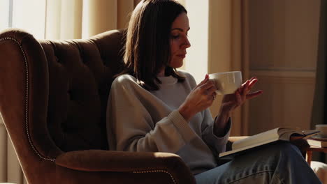 woman relaxing and reading by the window