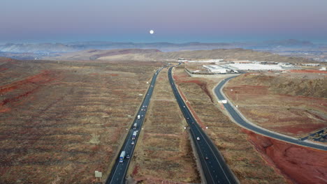 full moon over a desert highway at twilight
