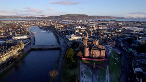 serene golden hour shot of inverness showcasing river, cityscape, and surrounding highlands