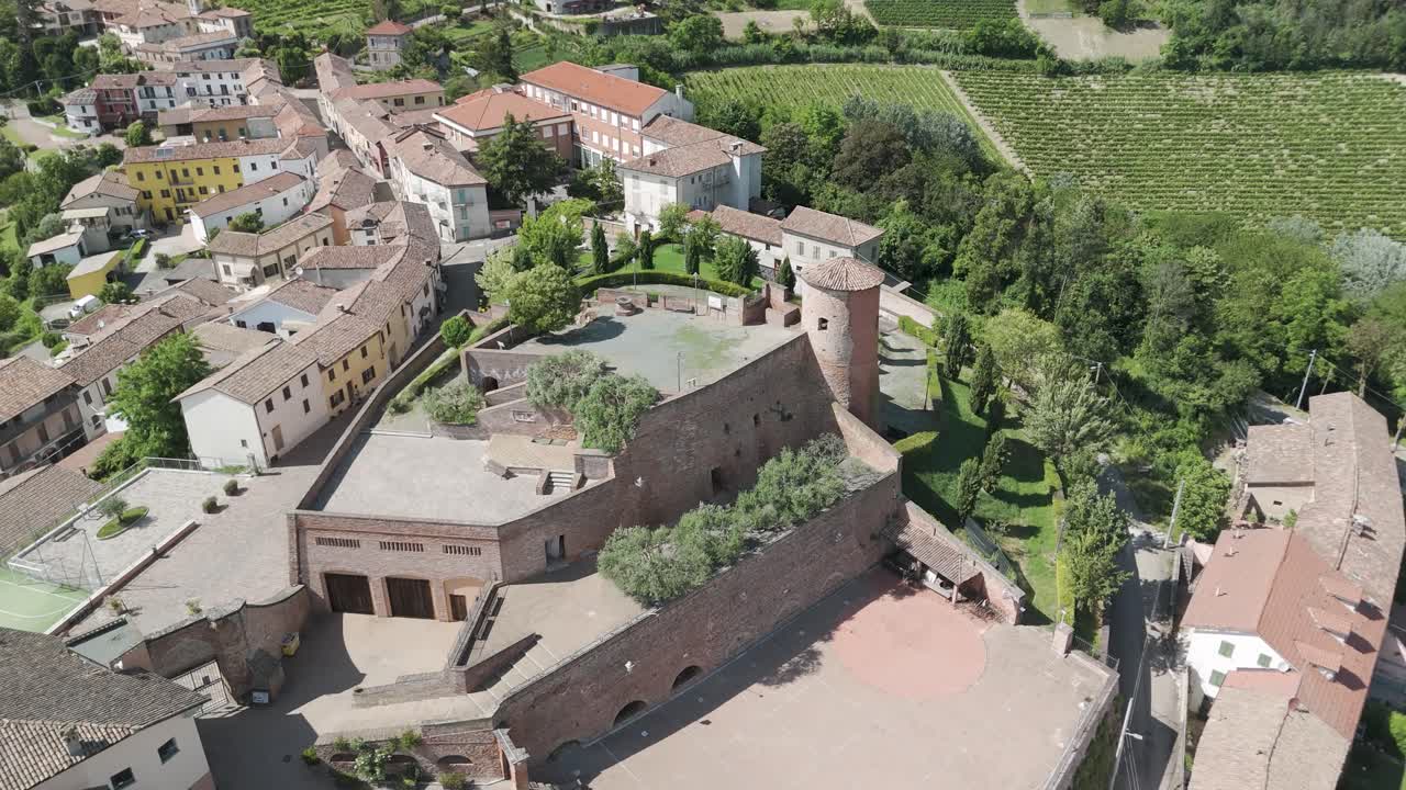 Castelnuovo Calcea, Monferrato region, Asti, Piedmont, Italy. 4k aerial view of the city. Langhe-Roero and Monferrato. Circling to the right aroud the castle and the city.
