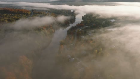 foggy atmosphere over autumnal landscape in sherbrooke town, quebec canada