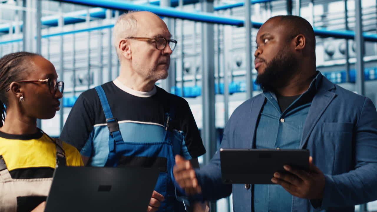 Smart factory engineering team colleagues implement automated workflows