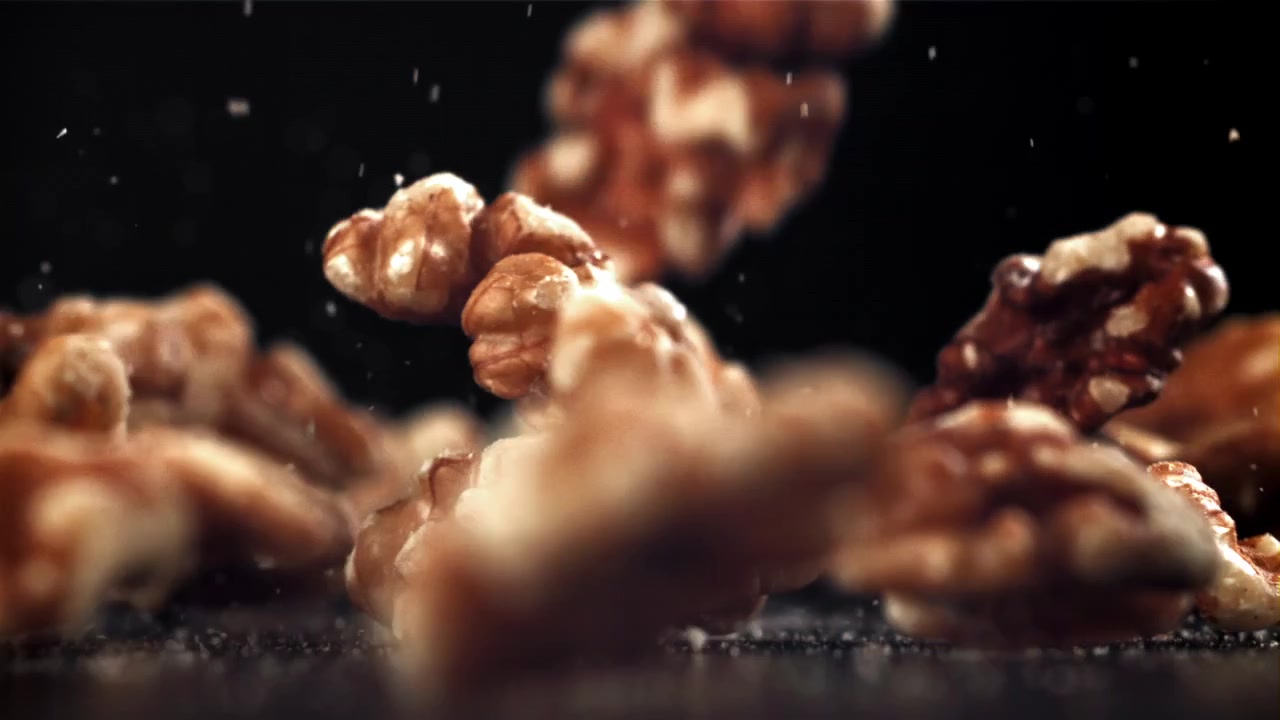 Walnuts Falling in Super Slow Motion on a Black Background