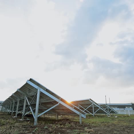 solar energy farm on the field. solar panels attached on metal basis on the ground. renewable source of energy. view from below.