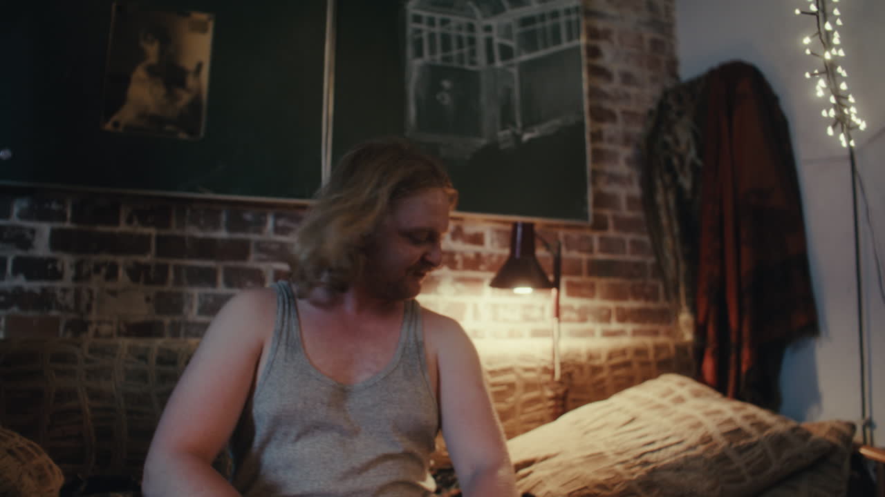 Man Sitting in a Cozy Bedroom