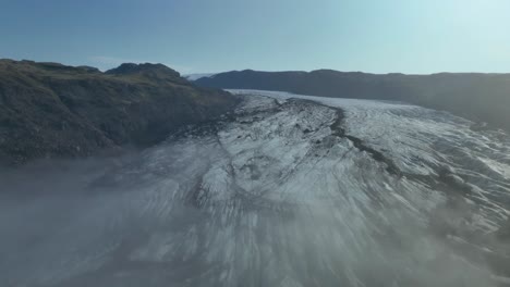 sólheimajokull glacier, south iceland - cloaked in morning mist - aerial pullback