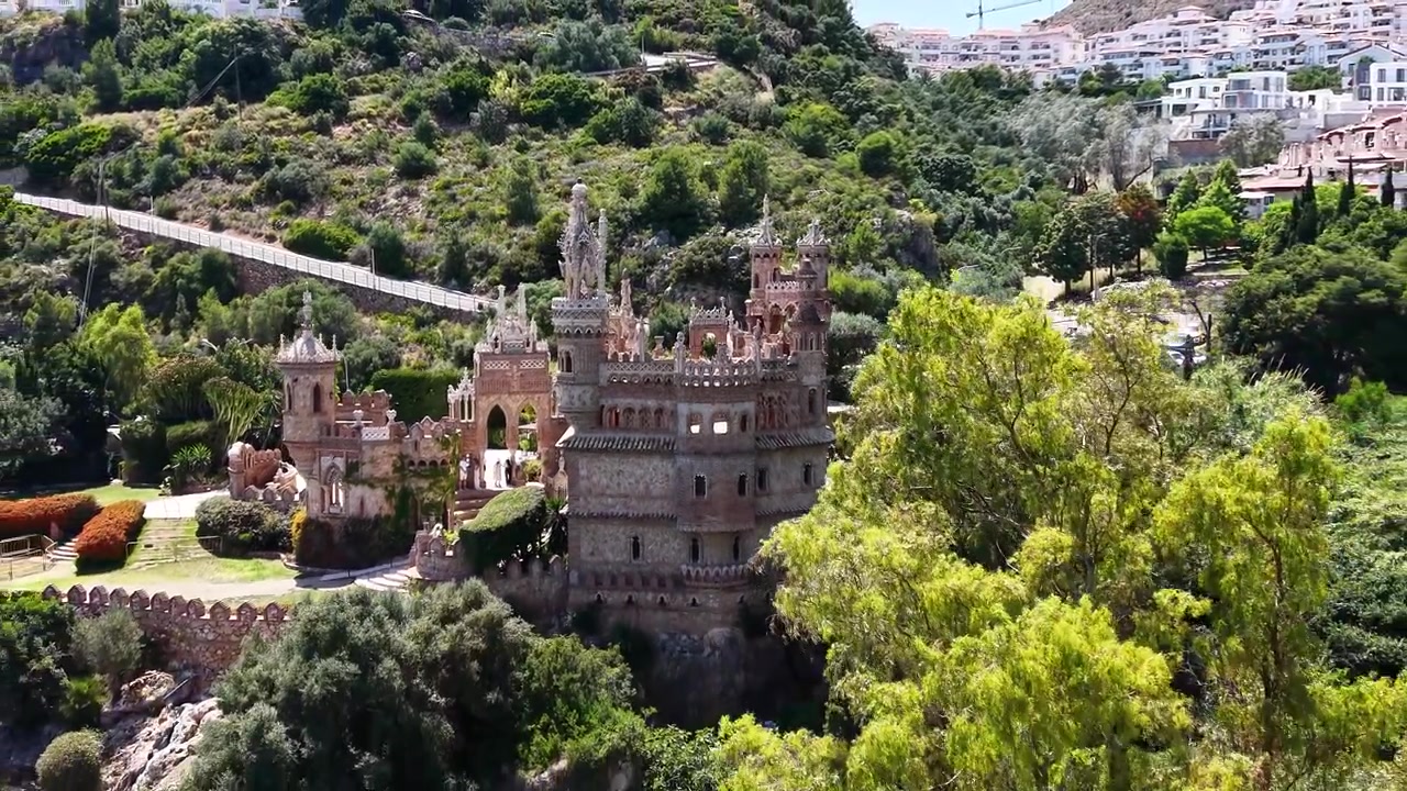 Drone-luftfoto af Colomares Slot, der viser dets udsmykkede tårne, dekorative arkitektur og indviklede detaljer i Benalmádena, Málaga, Andalusien, Spanien.