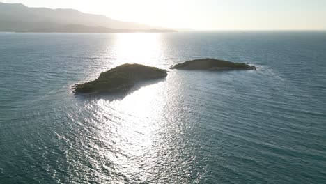 Sunlight-reflected-over-small-waves-on-the-blue-sea-with-the-mountains-of-Albania-in-the-background