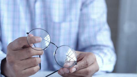 person cleaning glasses