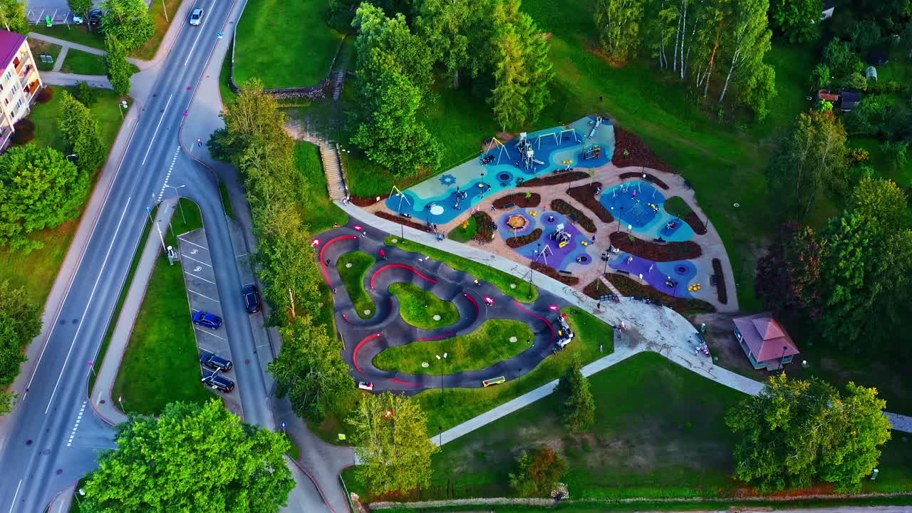 Colorful playground and pump track park captured from above on a bright summer day, Smiltene, Latvia