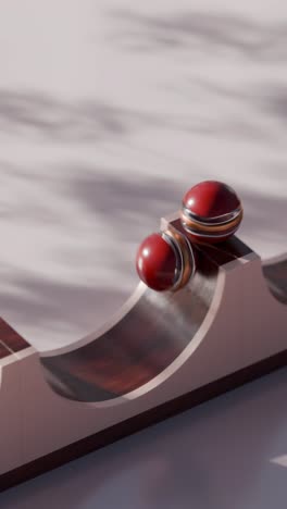 abstract geometric design with red and gold balls on wooden ramp