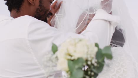 african american couple in love getting married, smiling and dancing on the beach
