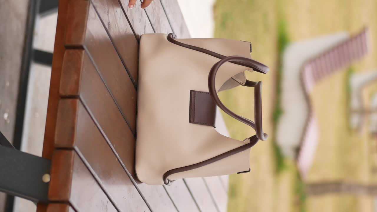 Beige Leather Tote Bag on Wooden Table