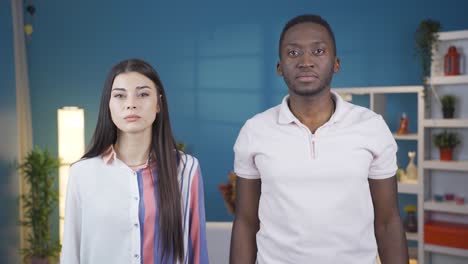 portrait of unhappy young couple resentful to each other. multi-ethnic marriage.