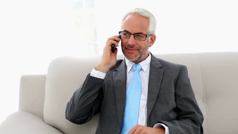 Businessman-talking-on-the-phone-on-the-couch