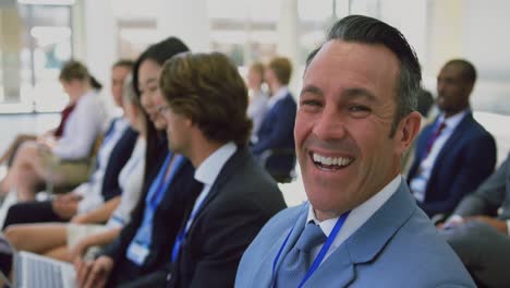 Businessman-looking-at-camera-during-seminar-4k