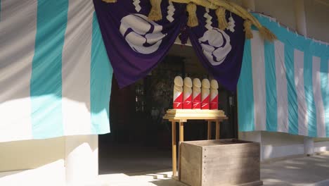 wooden penis idols at komatsu shrine on day of honensai, aichi japan