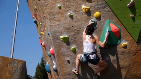 woman climbing on an outdoor rock wall