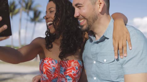 Diverse-bright-couple-taking-selfie