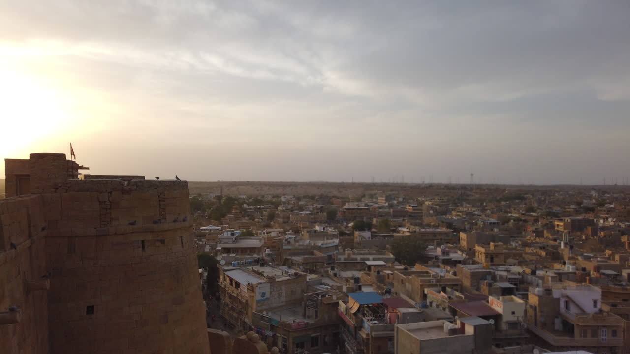 Low sun hyperlapse of an Indian city. The shot is taken from atop an old fort which gives a beautiful view of the sprawl below.