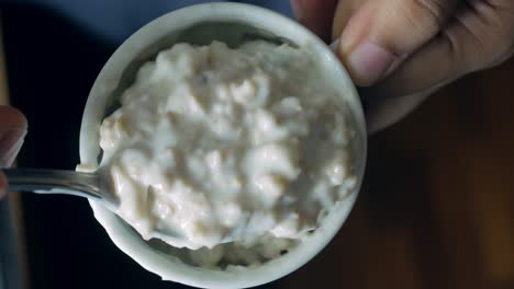 putting yogurt in granola musli in a bowl