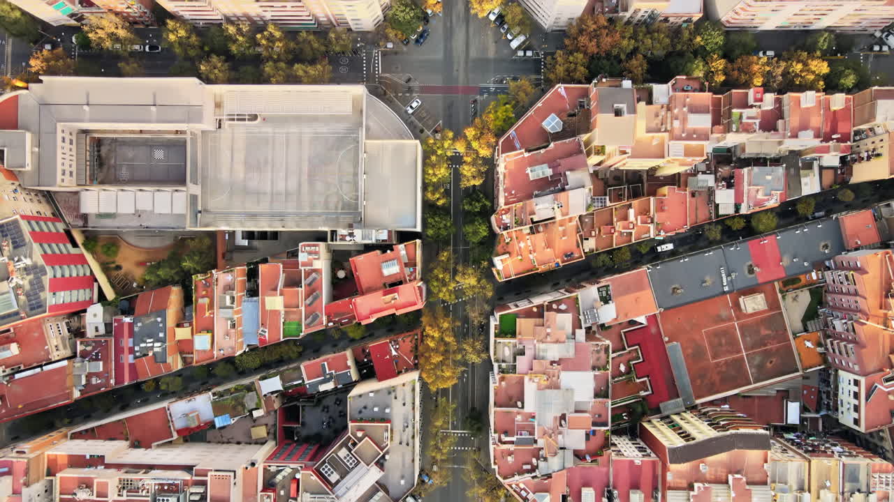 Aerial drone view of Barcelona, Spain. Blocks with multiple residential buildings, roads with cars
