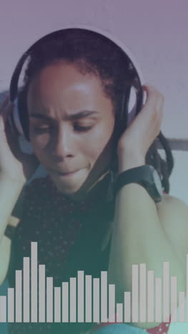 music equalizer against close up of african american woman wearing headphones listening to music