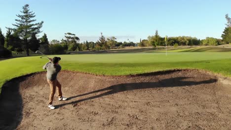 Two-diverse-male-golf-players-playing-golf-at-golf-course-on-sunny-day