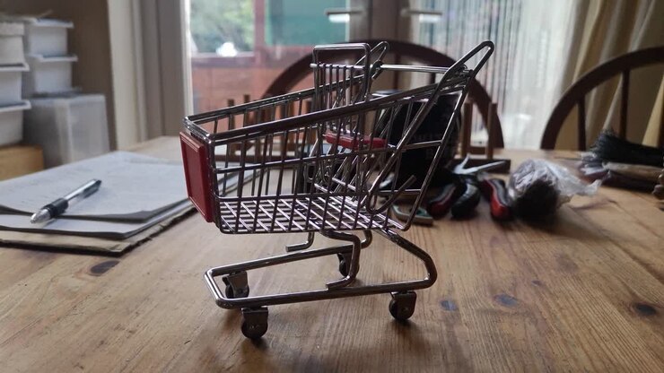 Small shopping trolley online home business concept on kitchen table copy space closeup left dolly shot