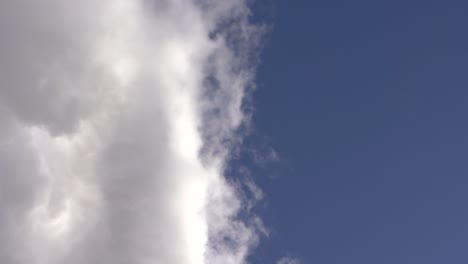 huge white clouds on a beautiful blue sky, crane shot