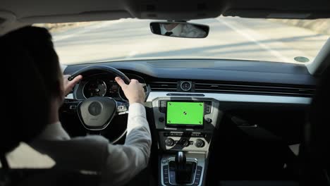 green screen on dashboard car panel with driving male person on background. navigating app. chromakey mockup. social networking. gps map 4g 5g