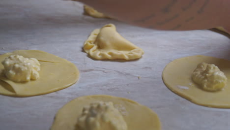 CLOSEUP-footage-of-a-woman-preparing-home-made-greek-cheese-pies